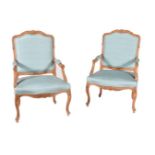 A pair of carved beech and blue upholstered fauteuil in Louis XV style