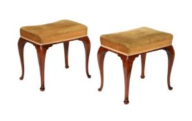 A pair of mahogany and upholstered stools