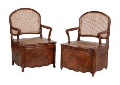 A pair of scumbled soft wood and cane work chair commodes