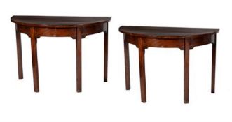 A pair of early George III mahogany side tables