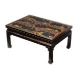 A black laquered and gilt decorated low centre table