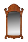 A walnut and inlaid fretwork wall mirror in 18th century style
