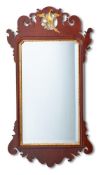 A GEORGE III MAHOGANY AND PARCEL GILT WALL MIRROR