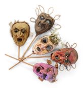 A GROUP OF FIVE MOULDED PAPER GROTESQUE CARNIVAL MASKS
