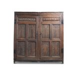 A CARVED OAK WARDROBE OR PRESS CUPBOARD, LATE 17TH CENTURY AND LATER