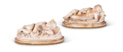 TWO SIMILAR ALABASTER MODELS OF RECUMBENT WINGED CUPIDS, 19TH CENTURY