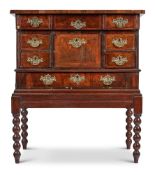 A WALNUT AND FEATHER BANDED SECRETAIRE CHEST ON STAND, INCORPORATING 18TH CENTURY AND LATER ELEMENTS