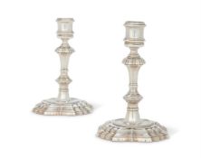 A MATCHED PAIR OF GEORGE II CAST SILVER CANDLESTICKS BY JAMES GOULD