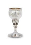 AN ARTS AND CRAFTS HAMMERED SILVER PRESENTATION GOBLET BY OMAR RAMSDEN & ALWYN CARR