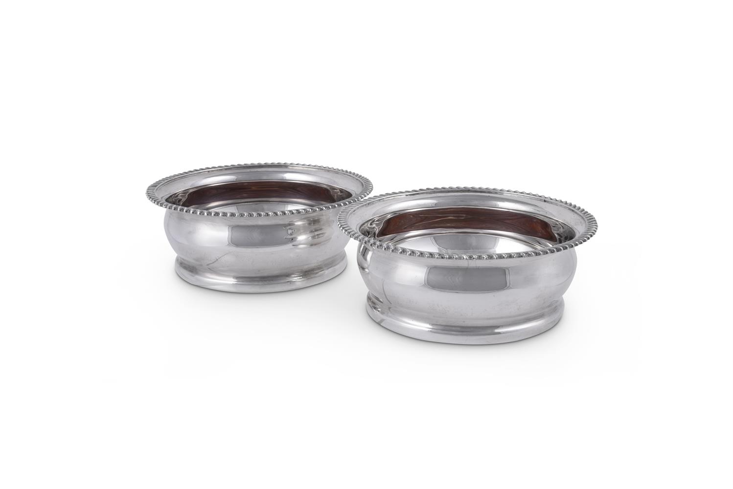 A PAIR OF SILVER CIRCULAR WINE COASTERS BY CAMELOT SILVERWARE LTD