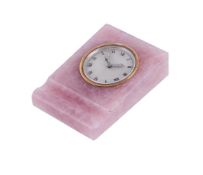 A ROSE QUARTZ MOUNTED ALARM CLOCK BY EUROPEAN WATCH & CLOCK CO. INC