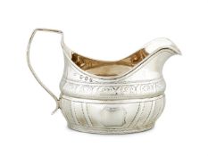 A GEORGE III IRISH SILVER OVAL BRIGHT-CUT CREAM JUG BY DANIEL EGAN