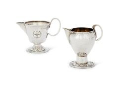 TWO ARTS AND CRAFTS HAMMERED SILVER CREAM JUGS BY A.E. JONES (ALBERT EDWARD JONES)