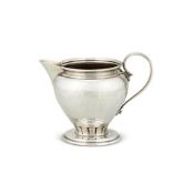 AN ARTS AND CRAFTS HAMMERED SILVER OVOID CREAM JUG BY LIBERTY & CO.