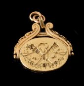 A FRENCH LATE 19TH CENTURY GOLD SWIVEL LOCKET FOB