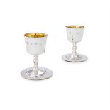 A CASED PAIR OF SILVER GOBLETS AND SILVER MOUNTED COASTERS BY BARKER ELLIS SILVER CO.