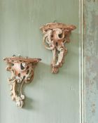 A PAIR OF GEORGE II CARVED SOFT WOOD WALL BRACKETS IN THE MANNER OF THOMAS JOHNSON, CIRCA 1755