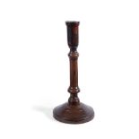 A RARE TREEN TURNED FRUITWOOD CANDLESTICK, 18TH CENTURY AND A TURNED SYCAMORE CANDLESTICK