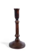 A RARE TREEN TURNED FRUITWOOD CANDLESTICK, 18TH CENTURY AND A TURNED SYCAMORE CANDLESTICK