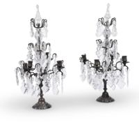 A PAIR OF PATINATED, MOULDED AND CUT-GLASS FOUR LIGHT CANDELABRA IN THE MANNER OF MAISON JANSEN