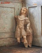 AN ITALIAN CARVED STONE FIGURE OF A CAVALIERE, EARLY 17TH CENTURY