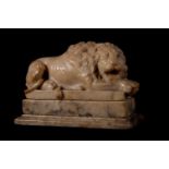 AN ITALIAN CARVED MARBLE MODEL OF A RECUMBENT LION AFTER ANTONIO CANOVA, EARLY 19TH CENTURY