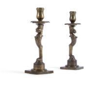 A PAIR OF REGENCY BRASS CANDLESTICKS, IN THE MANNER OF THOMAS HOPE, CIRCA 1820