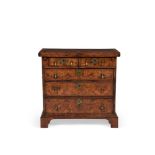 A FIGURED WALNUT AND FEATHER BANDED BACHELOR'S CHEST OF DRAWERS IN GEORGE II STYLE