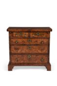 A FIGURED WALNUT AND FEATHER BANDED BACHELOR'S CHEST OF DRAWERS IN GEORGE II STYLE