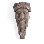 A GEORGE II CARVED SOFTWOOD AND PAINTED MASK WALL MOUNT PROBABLY IRISH, MID 18TH CENTURY