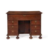 A WILLIAM III OAK KNEEHOLE DESK OR LIBRARY TABLE, CIRCA 1700