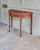 A GEORGE III MAHOGANY AND MARQUETRY DEMI-LUNE FOLDING CARD TABLEIN THE MANNER OF INCE AND MAYHEW