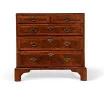 A GEORGE II WALNUT, CROSS BANDED AND FEATHER BANDED CHEST OF DRAWERS, CIRCA 1730