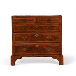 A GEORGE II WALNUT, CROSS BANDED AND FEATHER BANDED CHEST OF DRAWERS, CIRCA 1730