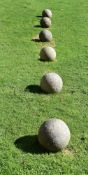A SET OF SIX CORNISH GRANITE BALLS, PROBABLY EARLY 20TH CENTURY