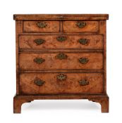 A GEORGE II FIGURED WALNUT AND FEATHER BANDED BACHELOR'S CHEST OF DRAWERS, CIRCA 1730