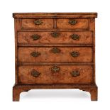 A GEORGE II FIGURED WALNUT AND FEATHER BANDED BACHELOR'S CHEST OF DRAWERS, CIRCA 1730