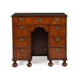 A QUEEN ANNE WALNUT AND FEATHER BANDED KNEEHOLE DESK, CIRCA 1710