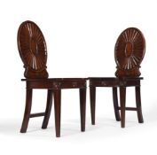 A PAIR OF GEORGE III MAHOGANY HALL CHAIRS, IN THE MANNER OF MAYHEW & INCE, CIRCA 1780