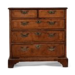 A GEORGE II WALNUT AND FEATHER BANDED BACHELOR'S CHEST OF DRAWERS, CIRCA 1740