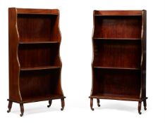 A PAIR OF MAHOGANY AND GILT METAL MOUNTED WATERFALL BOOKCASES, IN REGENCY STYLE