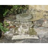 A CARVED LIMESTONE AND GLASS OCCASIONAL TABLE, LATE 19TH/20TH CENTURY