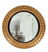 A LARGE REGENCY GILTWOOD AND GESSO CONVEX WALL MIRROR, CIRCA 1815