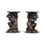A PAIR OF ITALIAN EBONISED AND PARCEL GILT 'BLACKAMOOR' STANDS OR TABLES, POSSIBLY VENETIAN