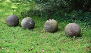 A SET OF FOUR COMPOSITION STONE SPHERES 20TH CENTURY