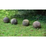 A SET OF FOUR COMPOSITION STONE SPHERES 20TH CENTURY