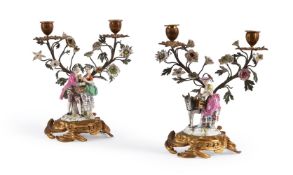 A PAIR OF GILT METAL AND PORCELAIN FIGURAL CANDELABRA, IN THE MID 18TH CENTURY FRENCH MANNER