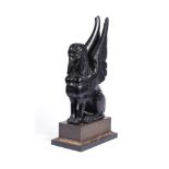 AN EBONISED MODEL OF A SPHINX, 19TH/20TH CENTURY