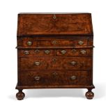 A QUEEN ANNE BURR WALNUT AND FEATHER BANDED BUREAU, CIRCA 1710