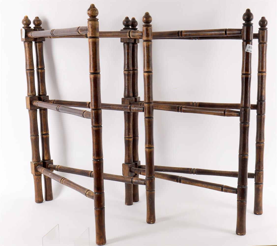 A pair of turned beech and brass mounted towel rails